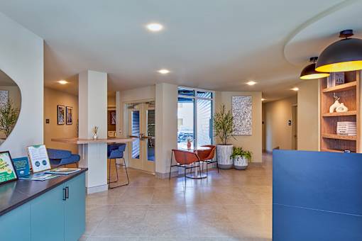 A modern interior with a reception desk and seating area.