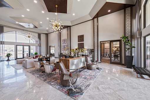 A large, well-lit room with a marble floor and a variety of seating options.
