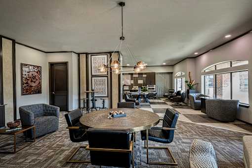 A modern living room with a large round table and comfortable seating.