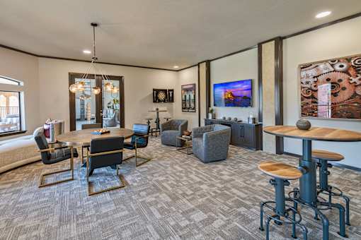 A modern living room with a grey carpet and a wooden coffee table.