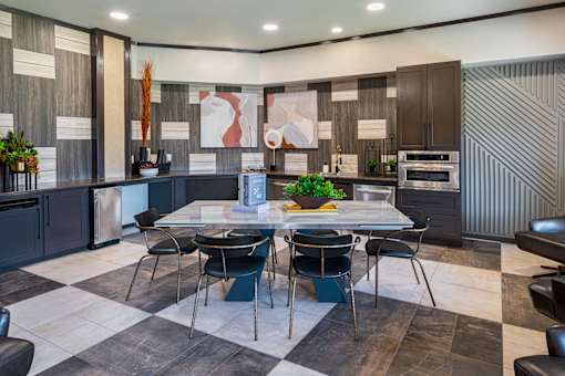 A modern kitchen with a dining table set for four.