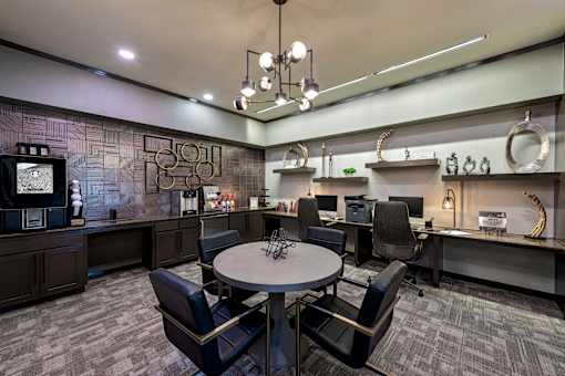A conference room with a table and chairs.
