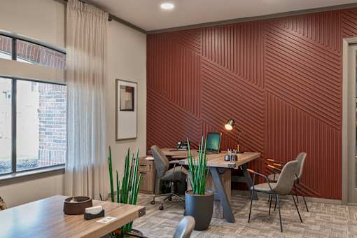 A modern office with a wooden table and chairs.