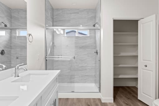 a white bathroom with a shower and a sink