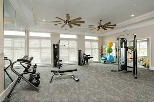A spacious home gym with a variety of equipment.