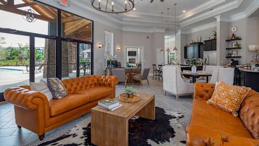A living room with a large orange sofa and a wooden coffee table.