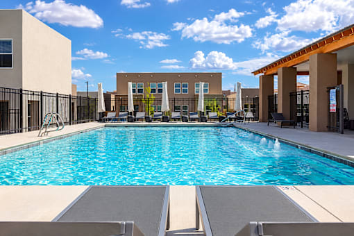 A large swimming pool in front of a building.