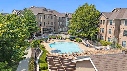 A large apartment complex with a pool in the middle.
