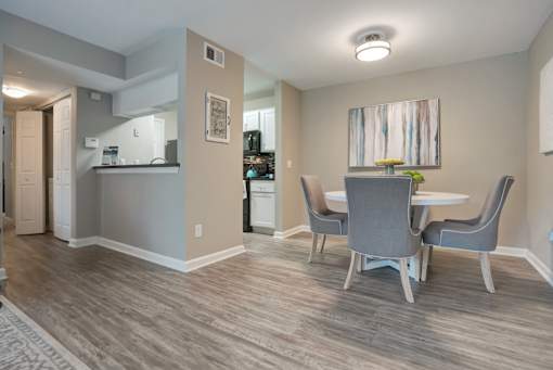 A dining room with a table and chairs.