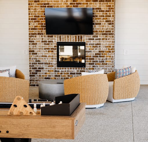 A living room with a fireplace and a tv above it.