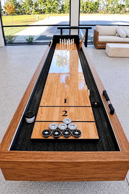A shuffleboard table with 1 and 2 marked on it.