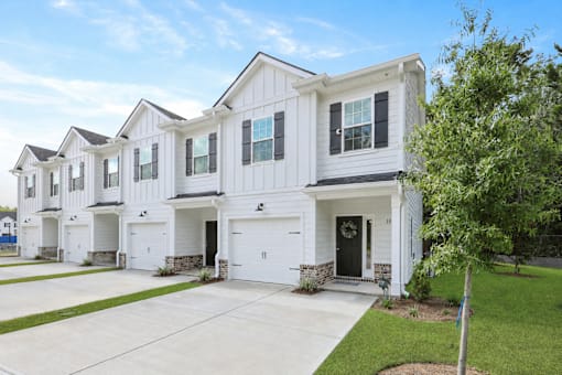 A white two-story house with a garage.