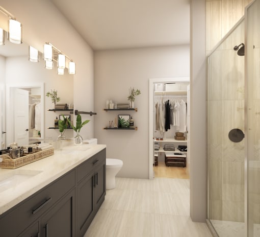 a bathroom with a large vanity and a walk in shower in a 555 waverly unit