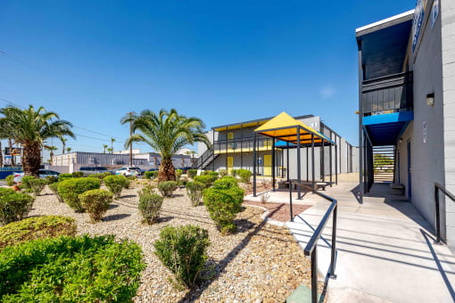 a building with a courtyard with palm trees