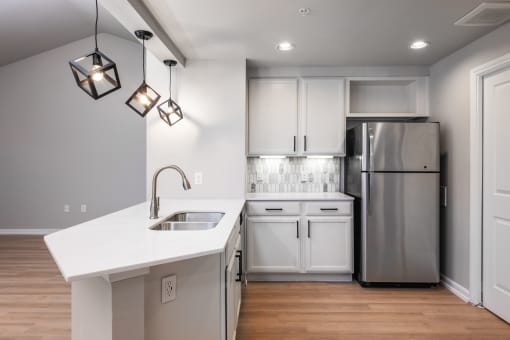 a kitchen with white cabinets and a white counter top