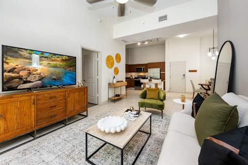 A modern living room with a flat screen TV and a coffee table.