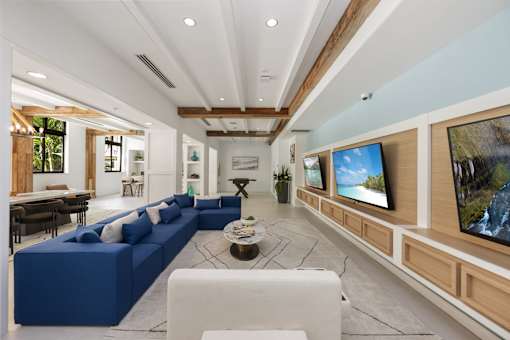 A modern living room with a blue sofa and a coffee table.