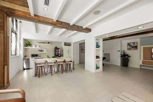 A modern kitchen with a dining area and a living room.