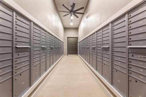 A long hallway with a row of mailboxes on either side.