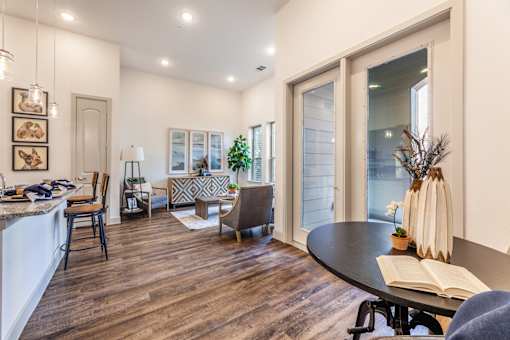 A modern kitchen with a dining table and chairs.