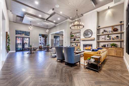 A spacious living room with a fireplace and a dining area.