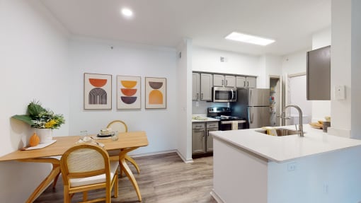 a kitchen and dining room with a table and chairs