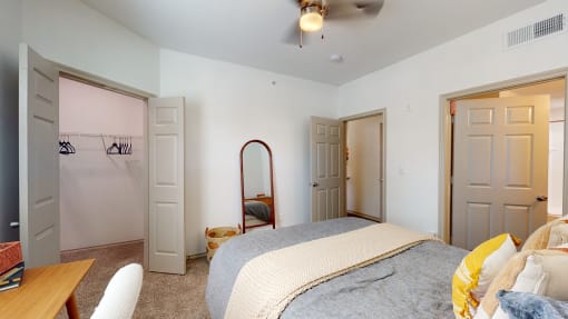 a bedroom with a large bed and two closets