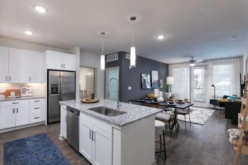 A modern kitchen with white cabinets and a large island.