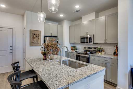 A kitchen with a granite countertop and a sink.