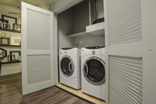 a washer and dryer in a laundry room with a closet