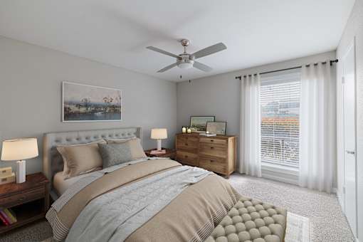 A bedroom with a large bed, a dresser, and a ceiling fan.