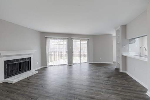 A spacious living room with a fireplace and sliding glass doors.
