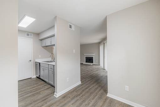 A kitchen with a white door and a white cabinet.