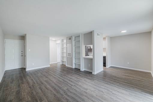 A room with wooden floors and white walls.