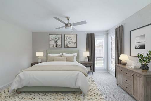A bedroom with a large bed, a ceiling fan, and a wooden dresser.