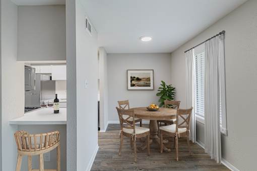 A dining room with a wooden table and chairs.