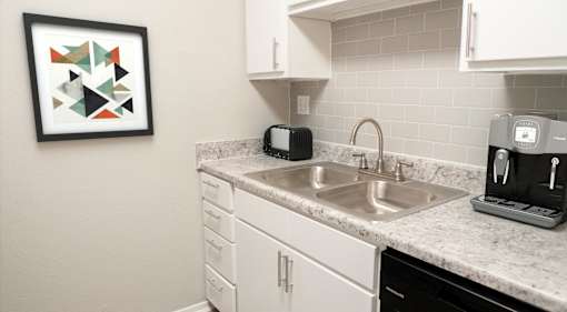 kitchen sink with white cabinets