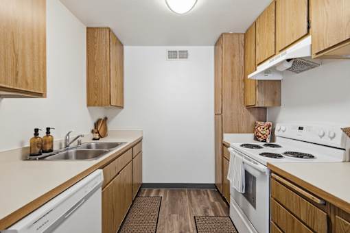 A kitchen with wooden cabinets and white appliances.