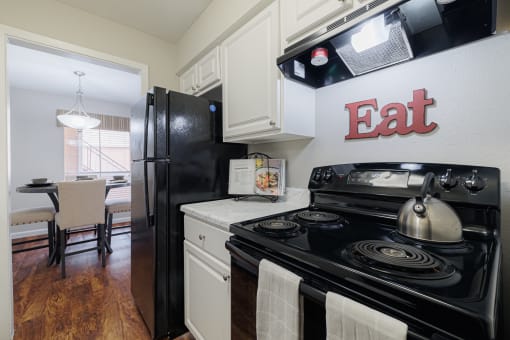 a kitchen with a black stove and a black refrigerator
