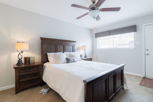 a bedroom with a large bed and a ceiling fan