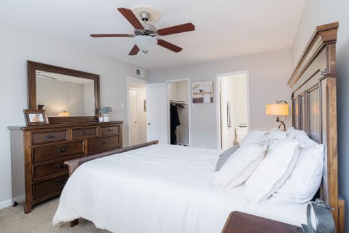 a bedroom with a large bed and a ceiling fan