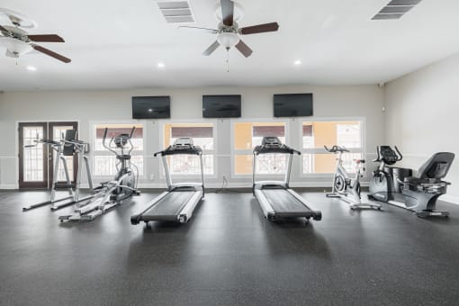 the gym with treadmills and weights at the apartments