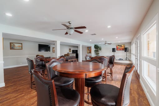 a dining room with a table and chairs and a ceiling fan