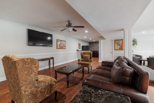 a living room with leather furniture and a tv