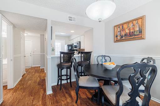 A dining room with a table set for two.
