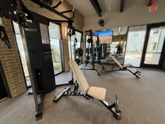 A gym with a variety of equipment including a leg press machine.