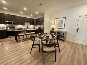 A modern kitchen with a dining table set for four.