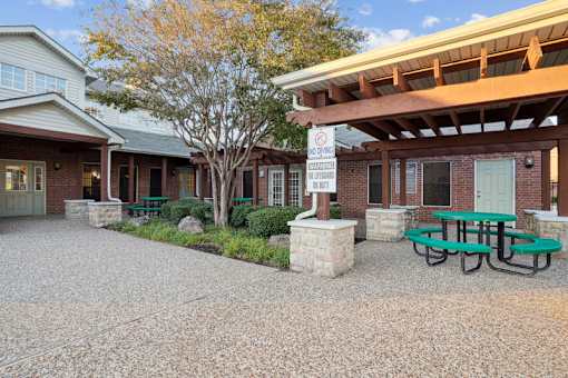 A building with a picnic table in front of it.