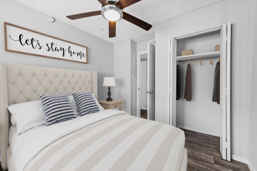 a bedroom with a large bed and a ceiling fan