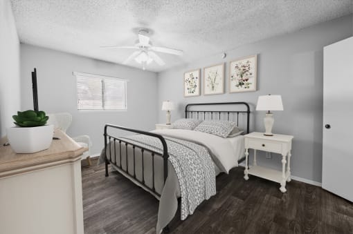 a bedroom with a bed and a ceiling fan